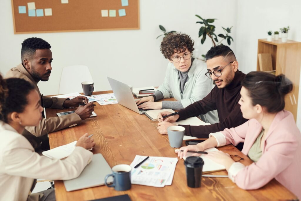 A diverse group of professionals engaged in a collaborative team meeting at the workplace.